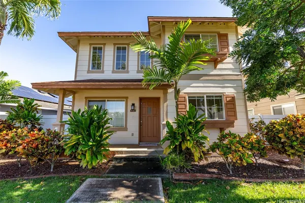 a front view of a house with plants