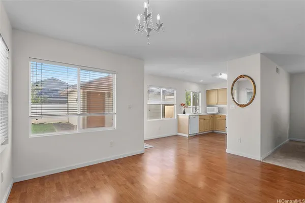 a view of a room with wooden floor and windows