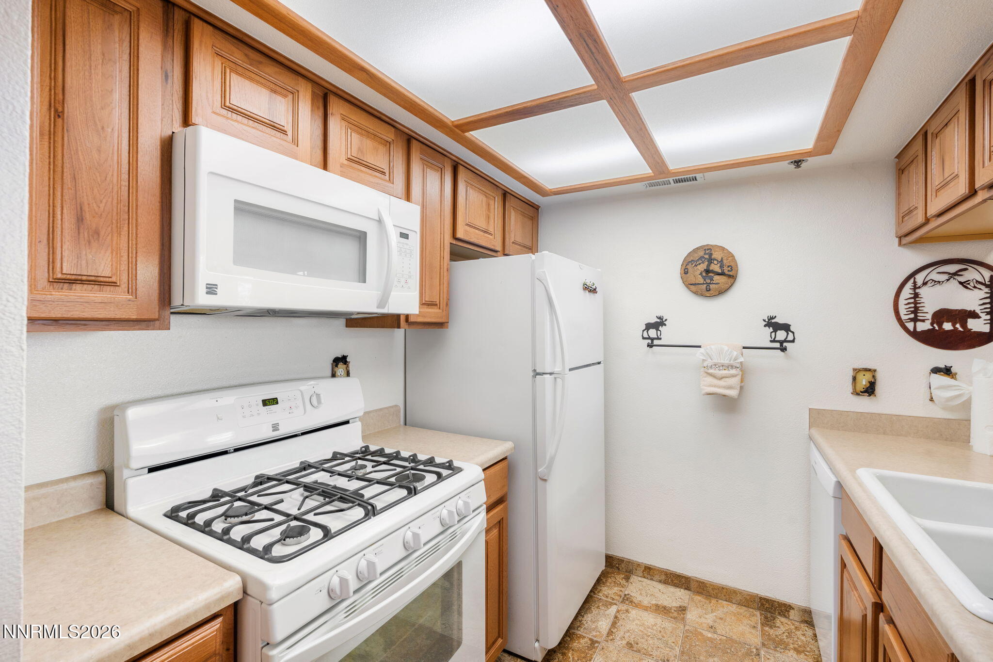 759 Boulder Court, Unit F Stateline, NV 89449 - Photo 13 of 36 a kitchen with stainless steel appliances a stove a refrigerator and a cabinets
