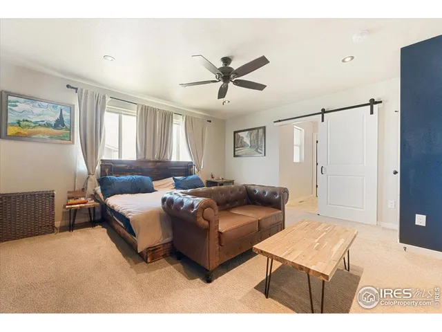 a living room with furniture and a ceiling fan