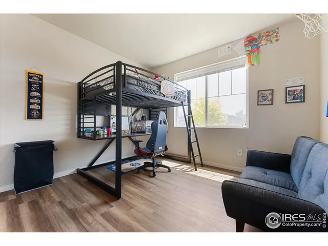 a living room with furniture a window and a wooden floor