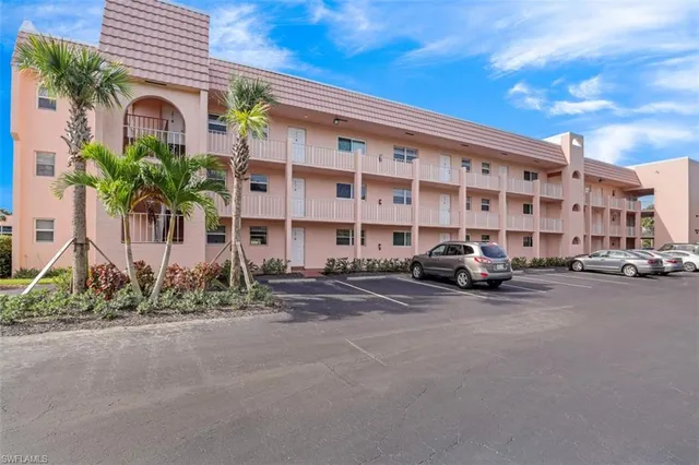 a front view of a building with a garden