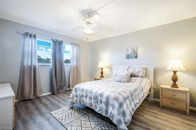 a bathroom with a sink a toilet a mirror a bathtub and shower