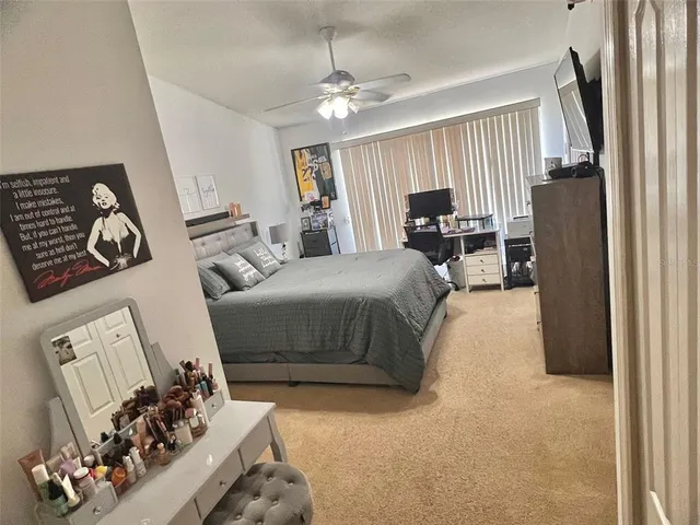 a bedroom with furniture and a large mirror