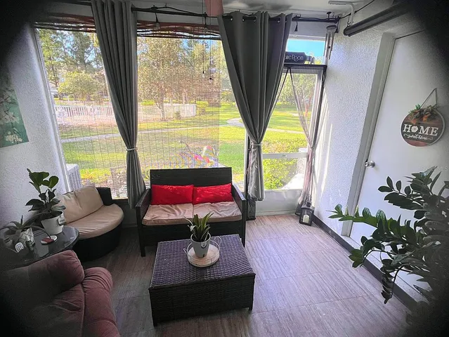 a living room with furniture and a large window