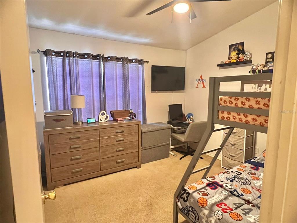 2435 Lake Woodberry Circle Brandon, FL 33510 - Photo 2 of 15 a bed room with a bed and a television