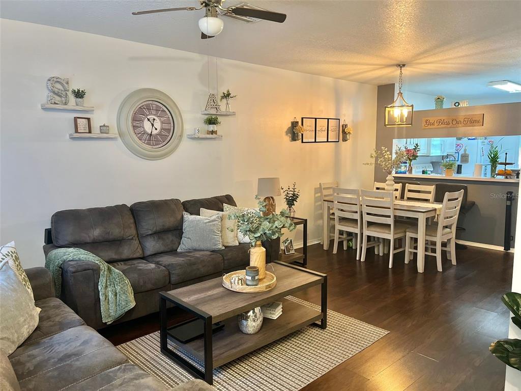 2435 Lake Woodberry Circle Brandon, FL 33510 - Photo 4 of 15 a living room with furniture a clock on wall and a window
