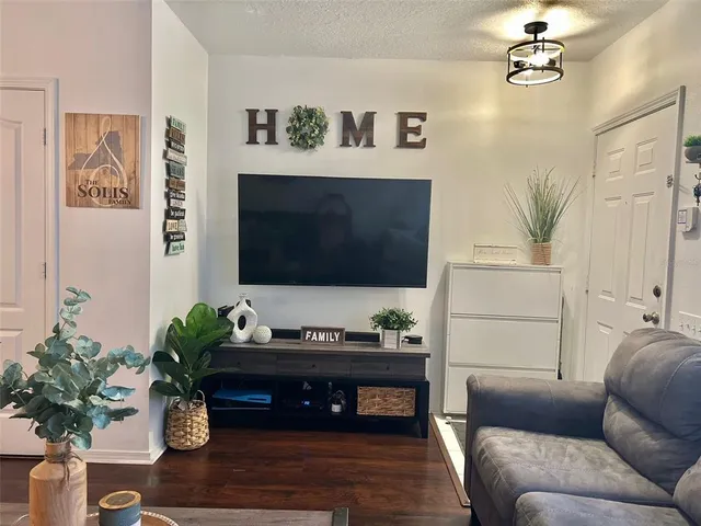 a living room with furniture fireplace and flat screen tv