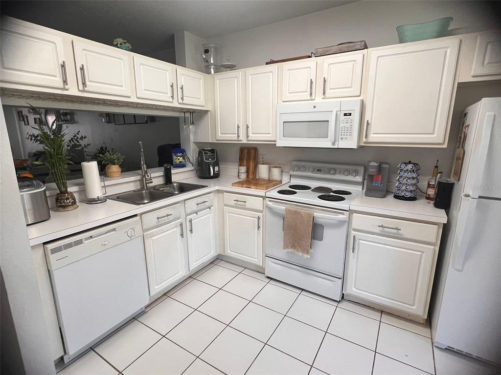 2435 Lake Woodberry Circle Brandon, FL 33510 - Photo 6 of 15 a kitchen with white cabinets appliances and a sink