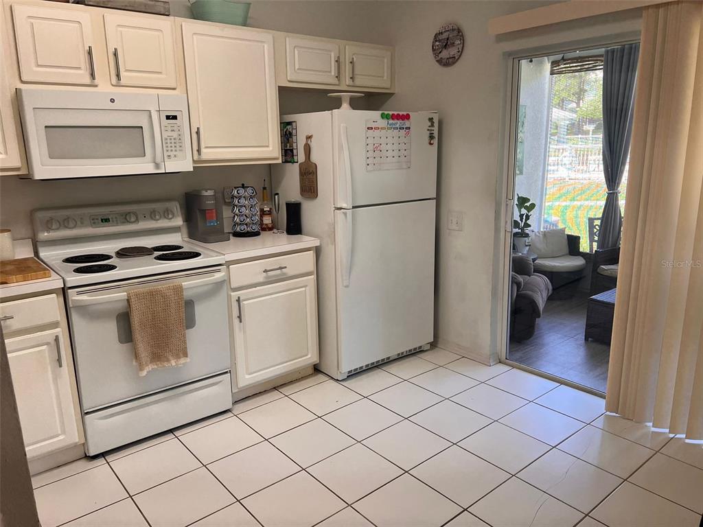 2435 Lake Woodberry Circle Brandon, FL 33510 - Photo 7 of 15 a kitchen with a refrigerator sink and cabinets