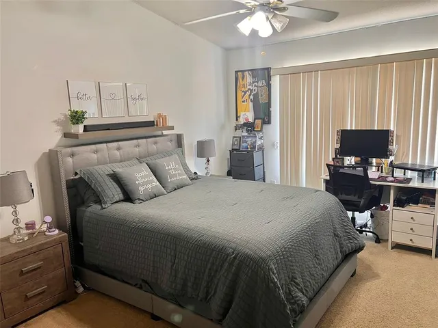 a bedroom with a bed and a television