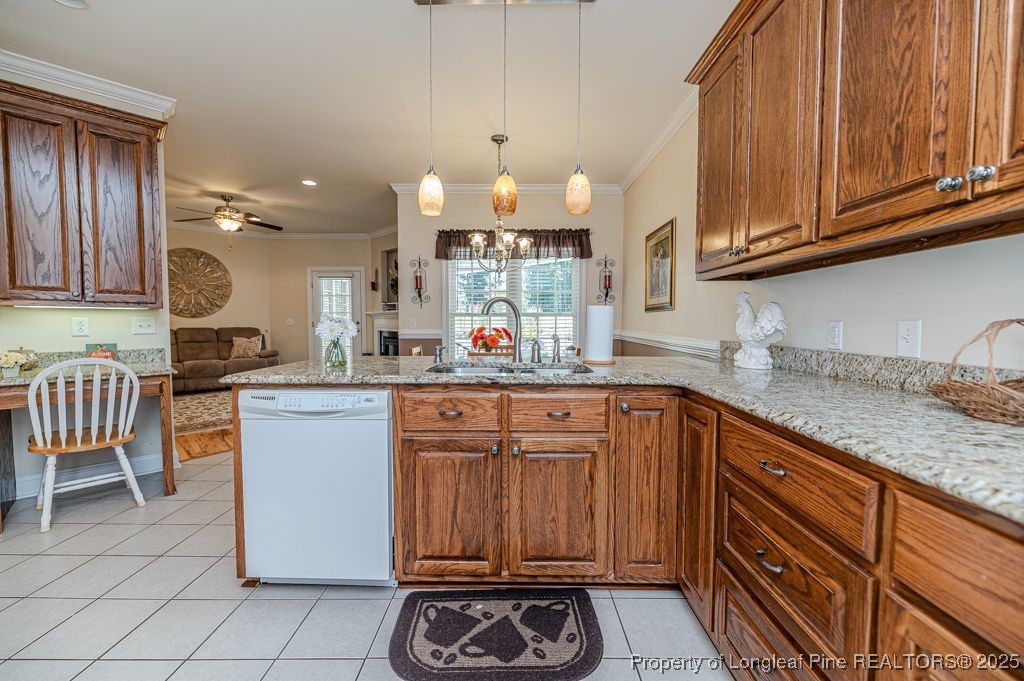 4635 Farrell Road Sanford, NC 27330 - Photo 13 of 30 a kitchen with granite countertop a sink cabinets and stainless steel appliances