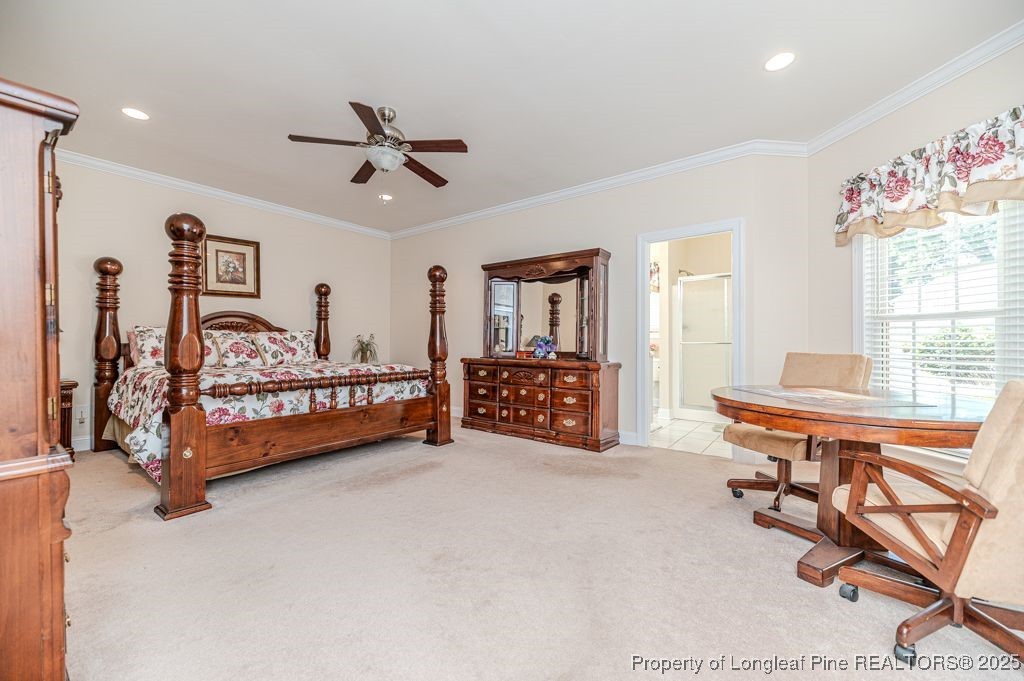 4635 Farrell Road Sanford, NC 27330 - Photo 14 of 30 a bedroom with a bed and a chandelier