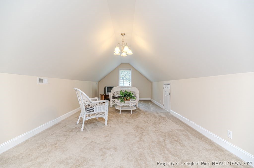 4635 Farrell Road Sanford, NC 27330 - Photo 23 of 30 a living room with furniture and a chandelier
