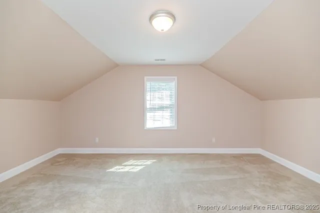 a view of a room with furniture and a chandelier