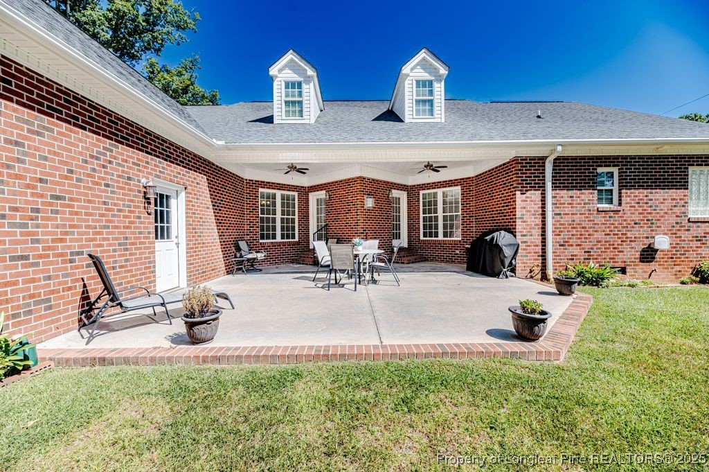 4635 Farrell Road Sanford, NC 27330 - Photo 27 of 30 a view of a patio with table and chairs potted plants with floor to ceiling window