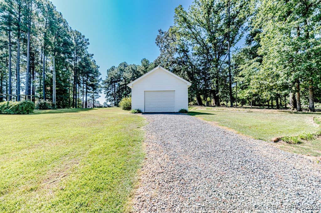 4635 Farrell Road Sanford, NC 27330 - Photo 29 of 30 a large tree in front of a house with yard and green space