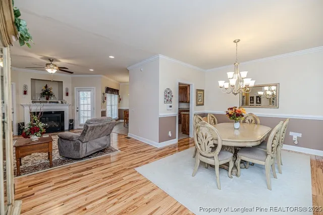 a view of a dining room with furniture wooden floor and chandelier