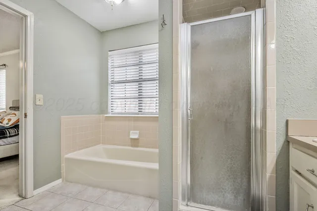 a bathroom with a bathtub and a shower