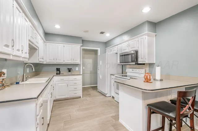 a kitchen with stainless steel appliances a stove sink microwave and cabinets