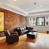 a living room with furniture window and wooden floor