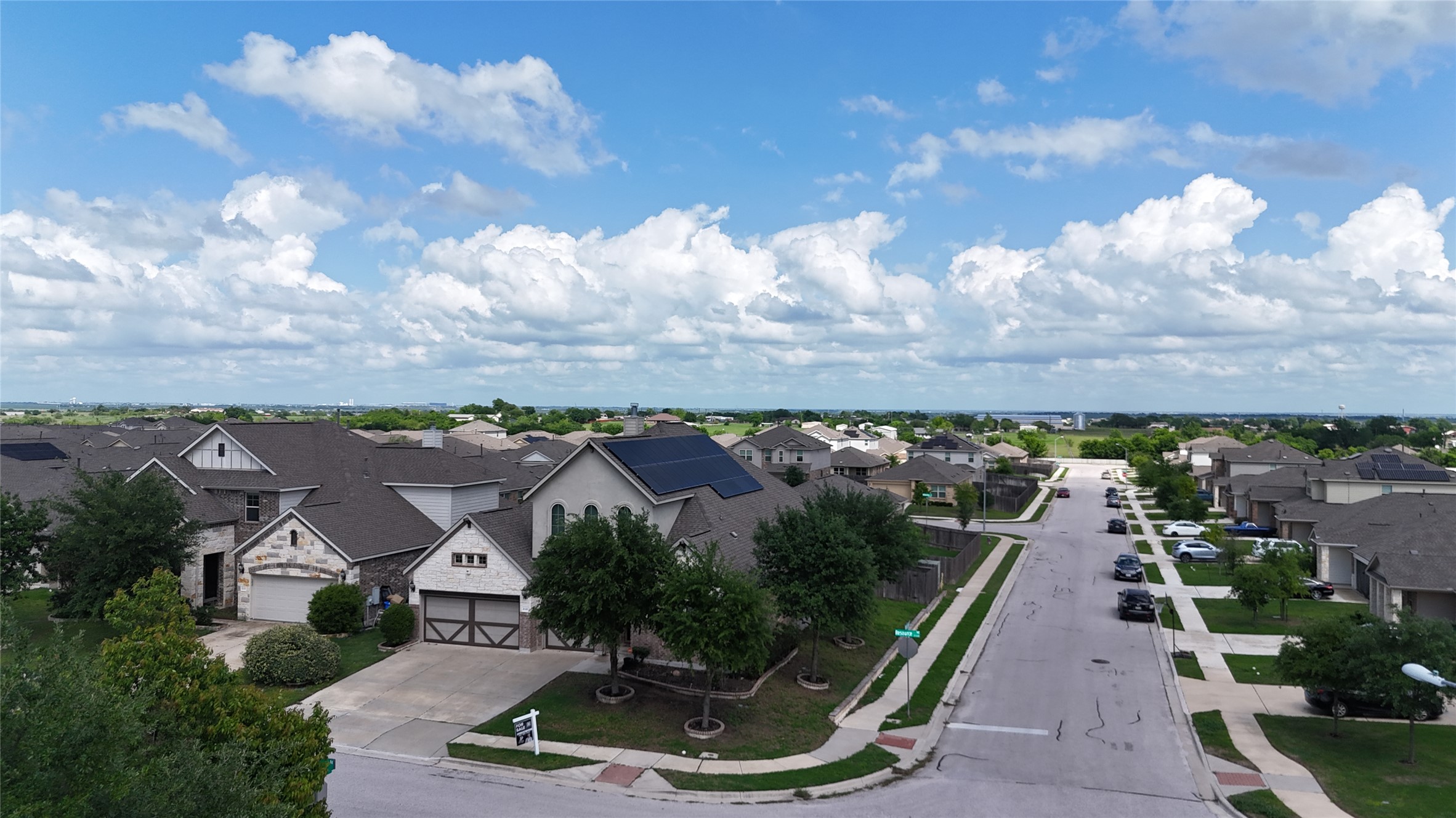 21301 Resource Road Pflugerville, TX 78660 - Photo 27 of 29 Residential street with multiple single-story homes featuring attached garages and varied architectural styles