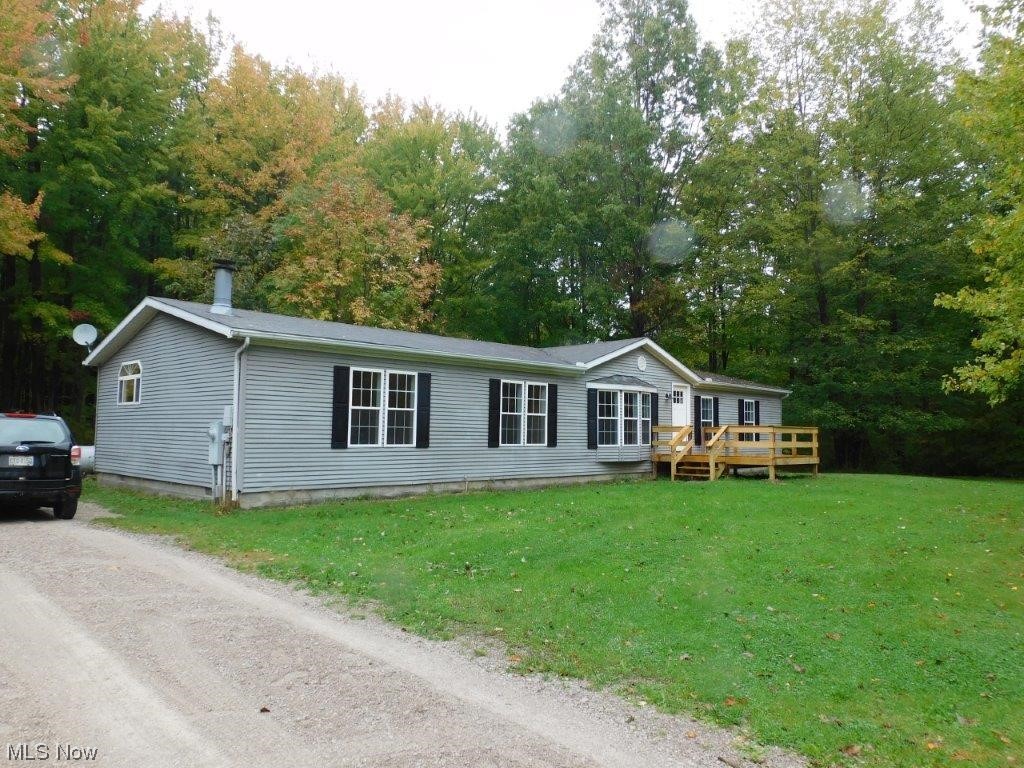 6045 Gore Road Ashtabula, OH 44004 - Photo 8 of 23 Manufactured / mobile home featuring a front lawn and a wooden deck