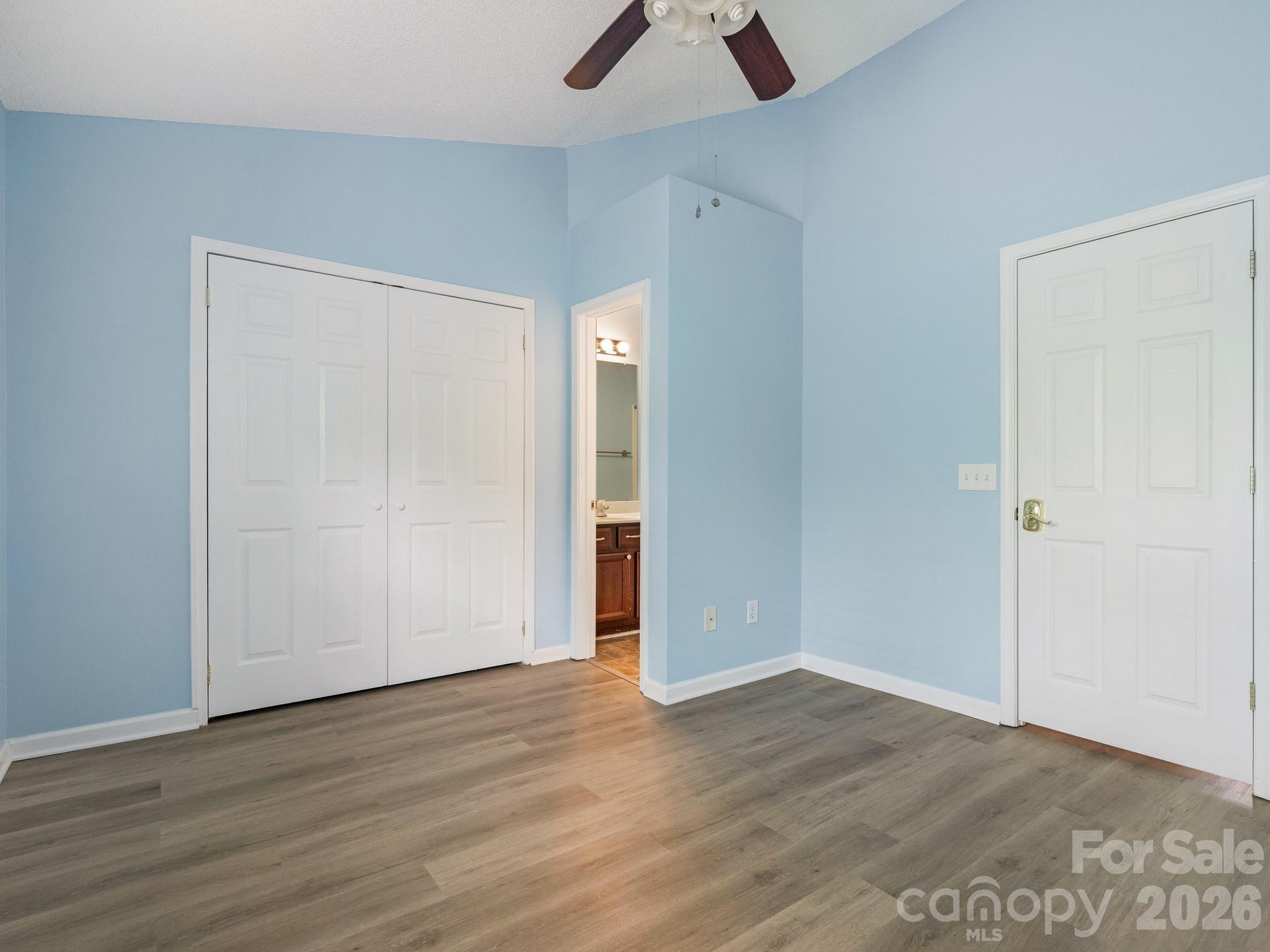3259 Blythe Ridge Court Charlotte, NC 28213 - Photo 10 of 17 an empty room with wooden floor and ceiling fan