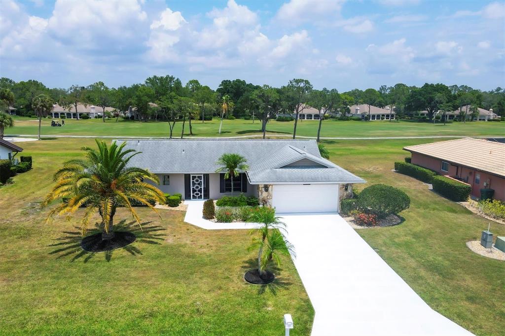 an aerial view of a house with big yard