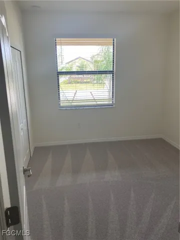 a bathroom with a granite countertop sink a mirror and shower