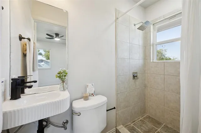 a bathroom with a sink toilet and shower