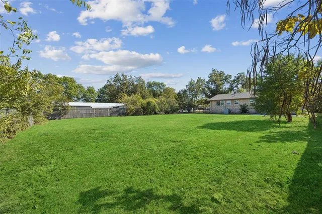 a view of yard with swimming pool and green space