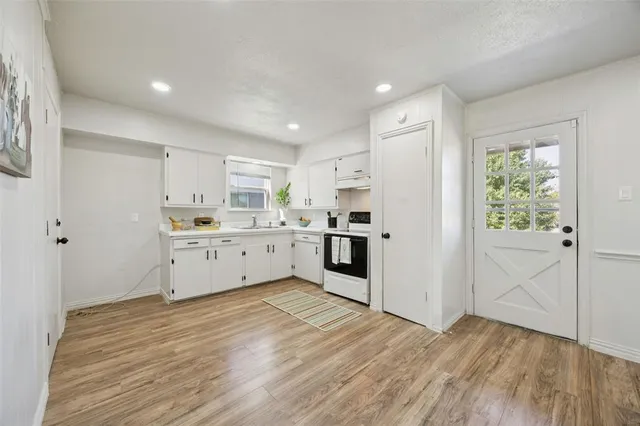 a view of a kitchen with wooden floor