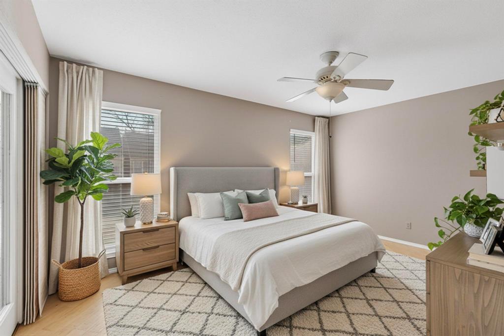 9222 Church Road, Unit 112 Dallas, TX 75231 - Photo 7 of 22 a bedroom with a large bed and a potted plant