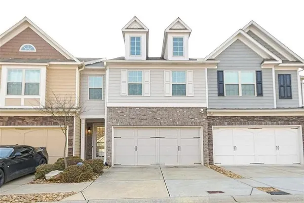 a front view of a house with a yard