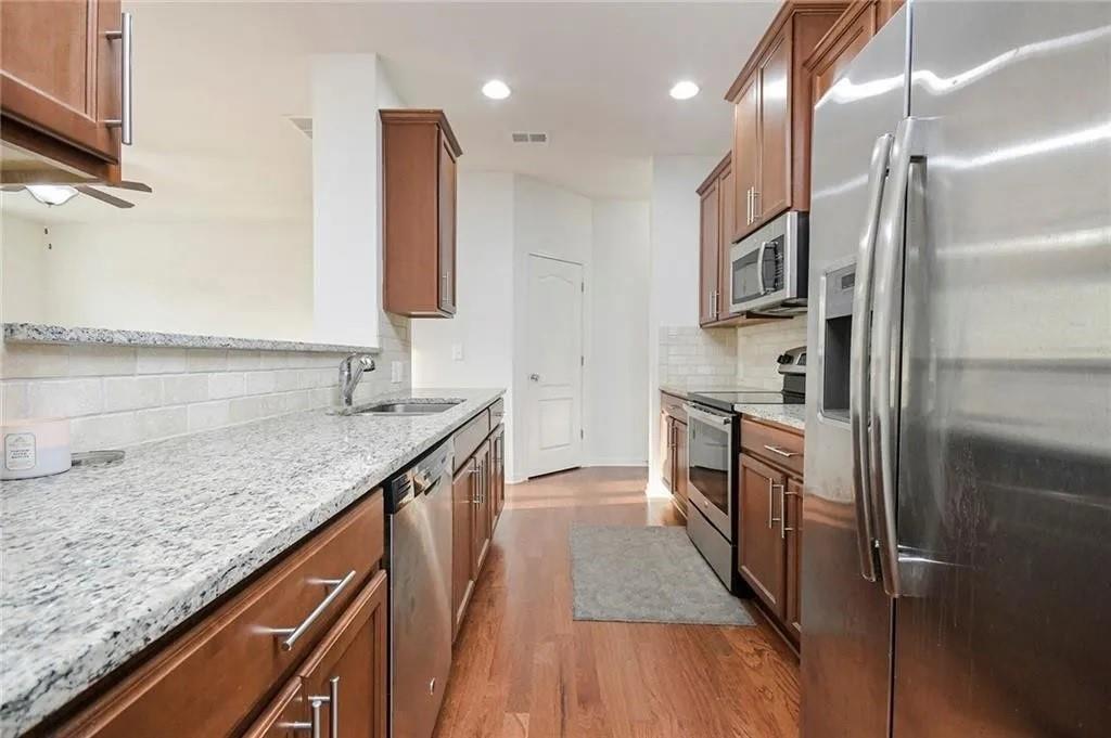 3934 Princeton Lakes Pass Southwest Atlanta, GA 30331 - Photo 14 of 35 a kitchen with stainless steel appliances granite countertop a sink and a refrigerator