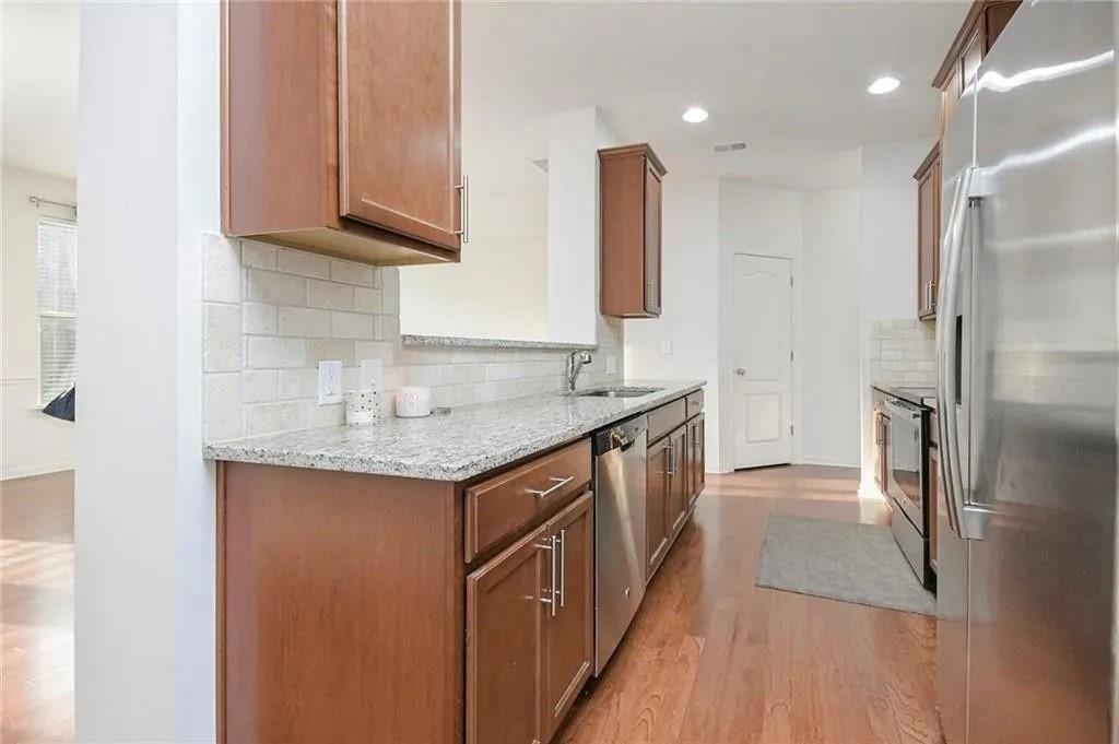 3934 Princeton Lakes Pass Southwest Atlanta, GA 30331 - Photo 15 of 35 a kitchen with stainless steel appliances granite countertop a sink and a refrigerator
