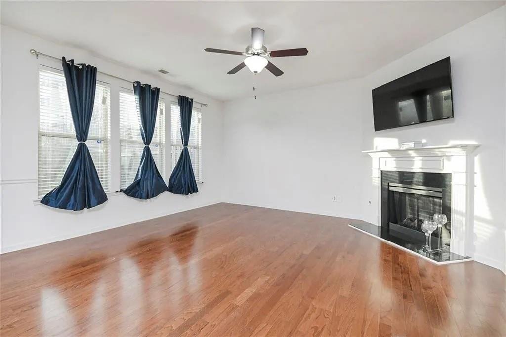 3934 Princeton Lakes Pass Southwest Atlanta, GA 30331 - Photo 22 of 35 a view of a livingroom with wooden floor and a ceiling fan