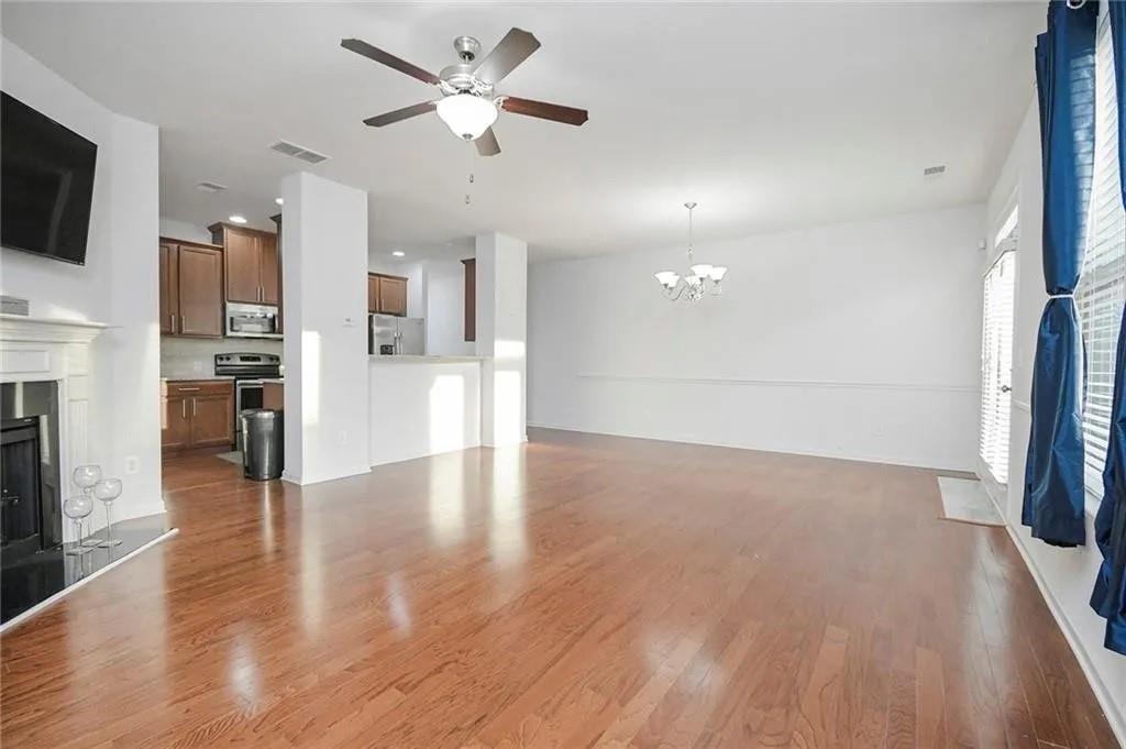 3934 Princeton Lakes Pass Southwest Atlanta, GA 30331 - Photo 25 of 35 a view of a kitchen with a kitchen island wooden floor and a ceiling fan