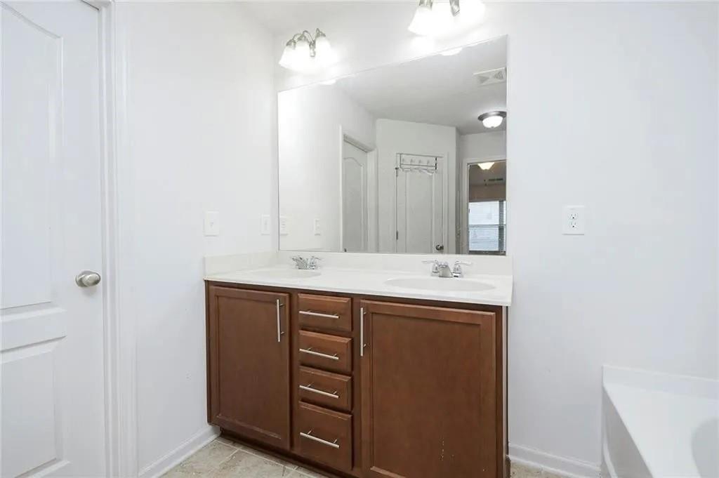 3934 Princeton Lakes Pass Southwest Atlanta, GA 30331 - Photo 29 of 35 a bathroom with a sink and a mirror