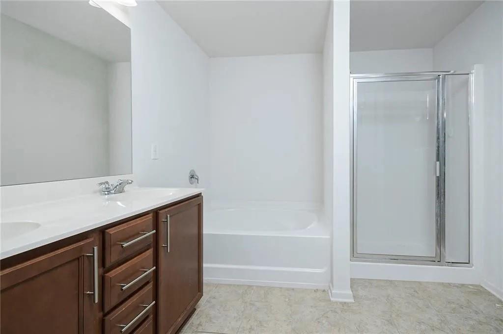 3934 Princeton Lakes Pass Southwest Atlanta, GA 30331 - Photo 30 of 35 a bathroom with a bathtub sink vanity and mirror
