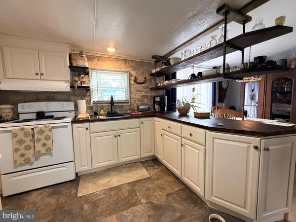 a kitchen with stainless steel appliances granite countertop a sink and cabinets