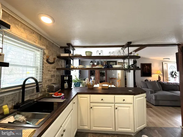 a kitchen with granite countertop a sink and cabinets