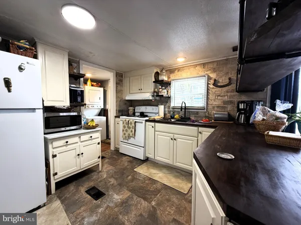 a kitchen with a sink a stove and cabinets