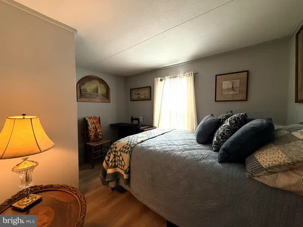 a bedroom with a bed and painting on the wall