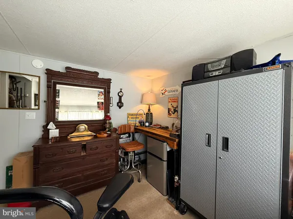 a room with a sink and a refrigerator