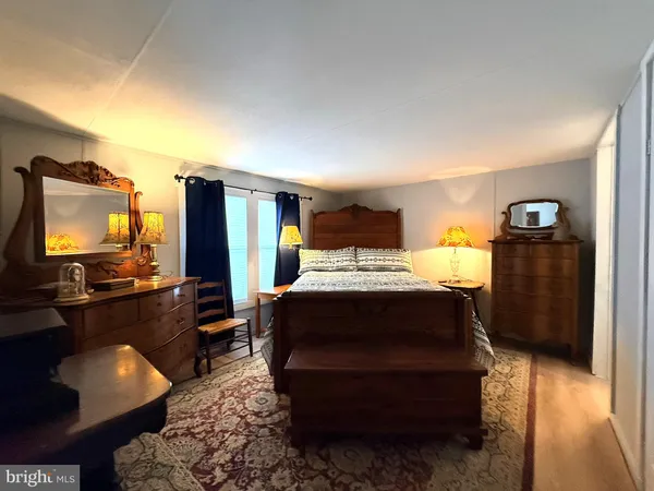 a bed sitting in a bedroom and chair