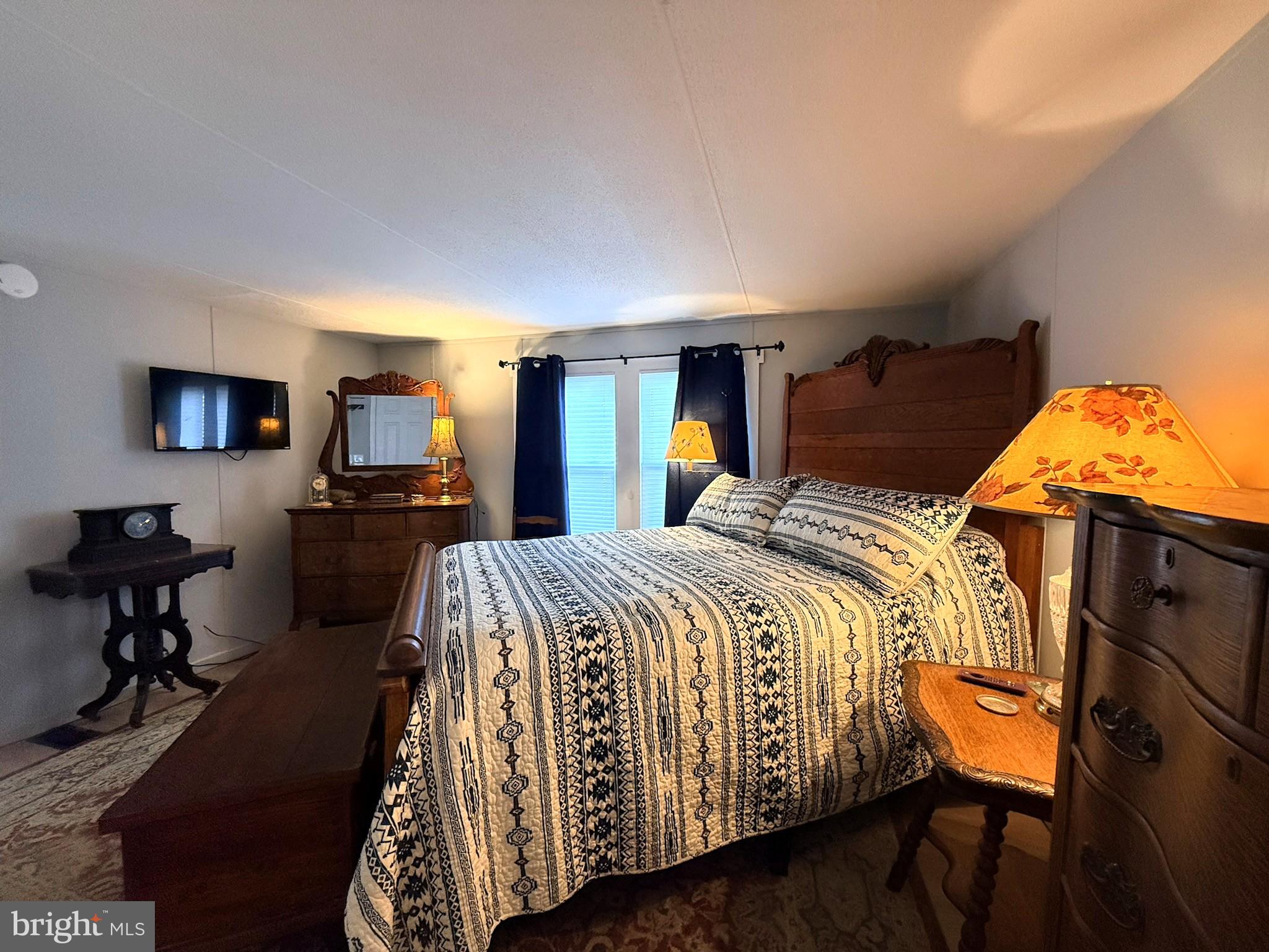 260 Marshall Mill Road, Unit 146 Malaga, NJ 08328 - Photo 27 of 34 a bed sitting in a bedroom and view of living room