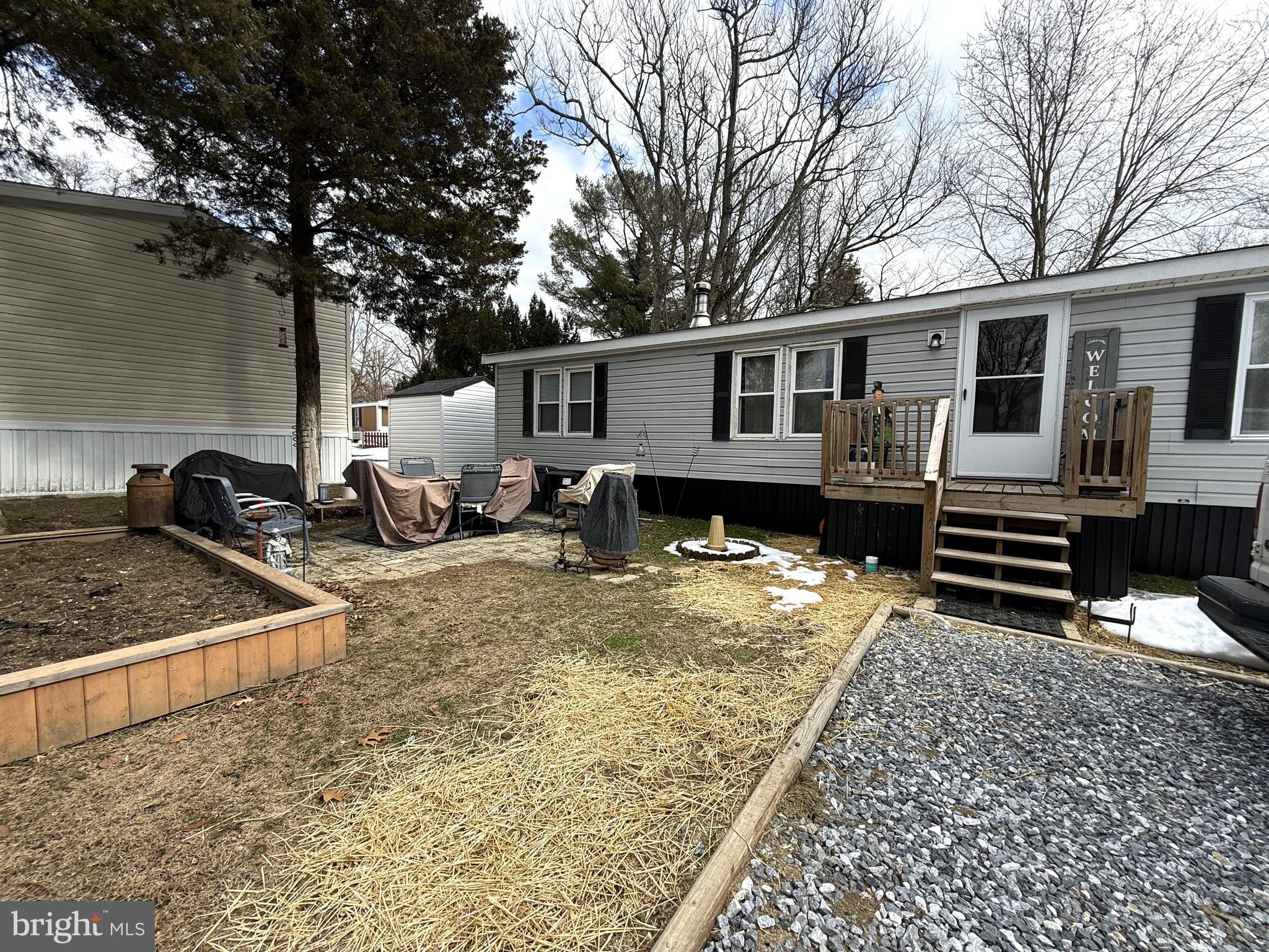 260 Marshall Mill Road, Unit 146 Malaga, NJ 08328 - Photo 34 of 34 a backyard of a house with barbeque oven and outdoor seating