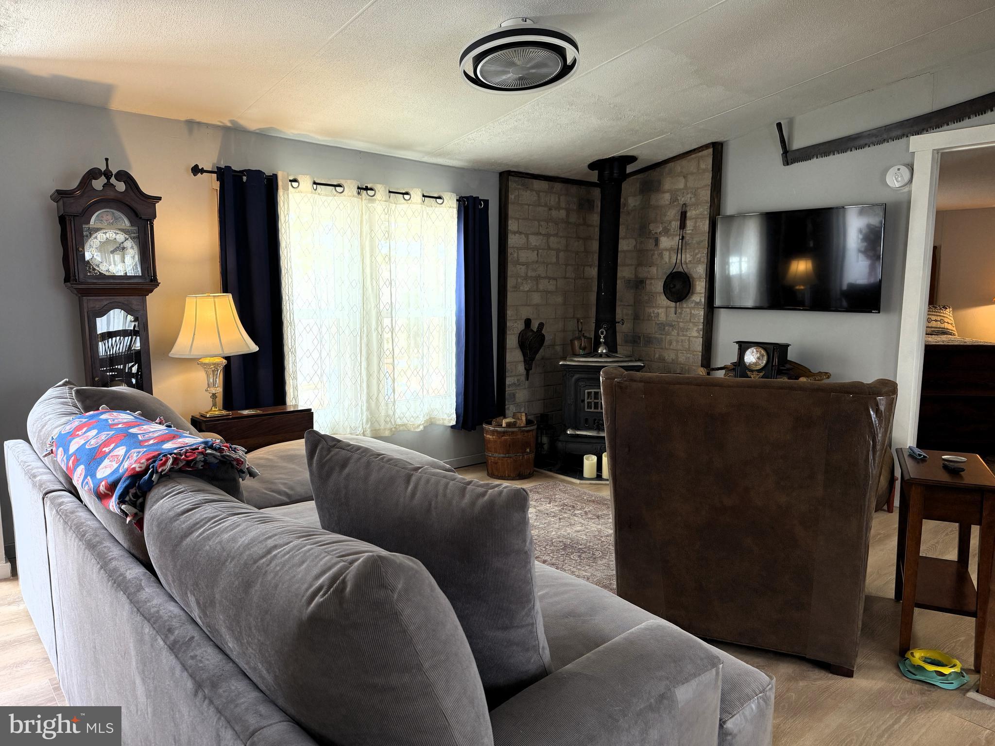 260 Marshall Mill Road, Unit 146 Malaga, NJ 08328 - Photo 5 of 34 a living room with furniture and a flat screen tv